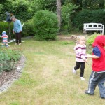 kids sword fighting in the garden