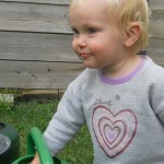 macey's fav thing to do-play in the watering cans